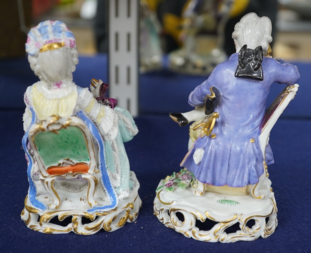 A pair of 19th century Meissen figures of a girl holding a shell and a boy holding a book, in size model number 628, tallest 13cm